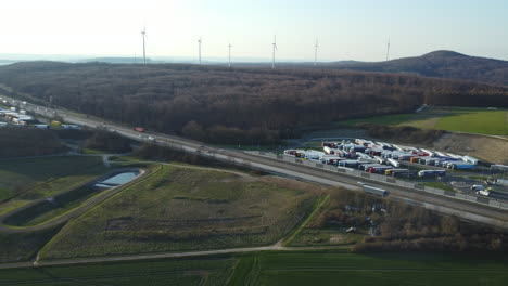 aerial view of highway, truck stop, and wind turbines