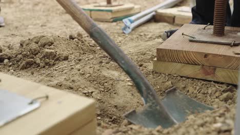 close up, scooping dirt with shovel at a construction site