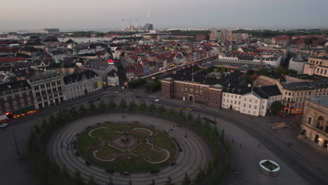 Aerial-Evening-View-of-Kongens-Nytorv-and-Nyhavn,-Showcasing-City-Life-with-Warm-Lighting-and-People