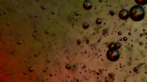 bubbles blowing up into a tough substance with a colored background