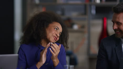 Diverse-colleagues-celebrating-success-high-five-in-business-company-office.