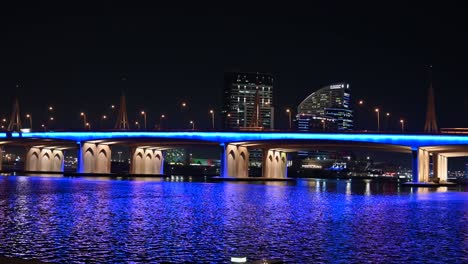 december 2020: traffic movement on dubai's business bay bridge at night, dubai night life, united arab emirates. 4k footage