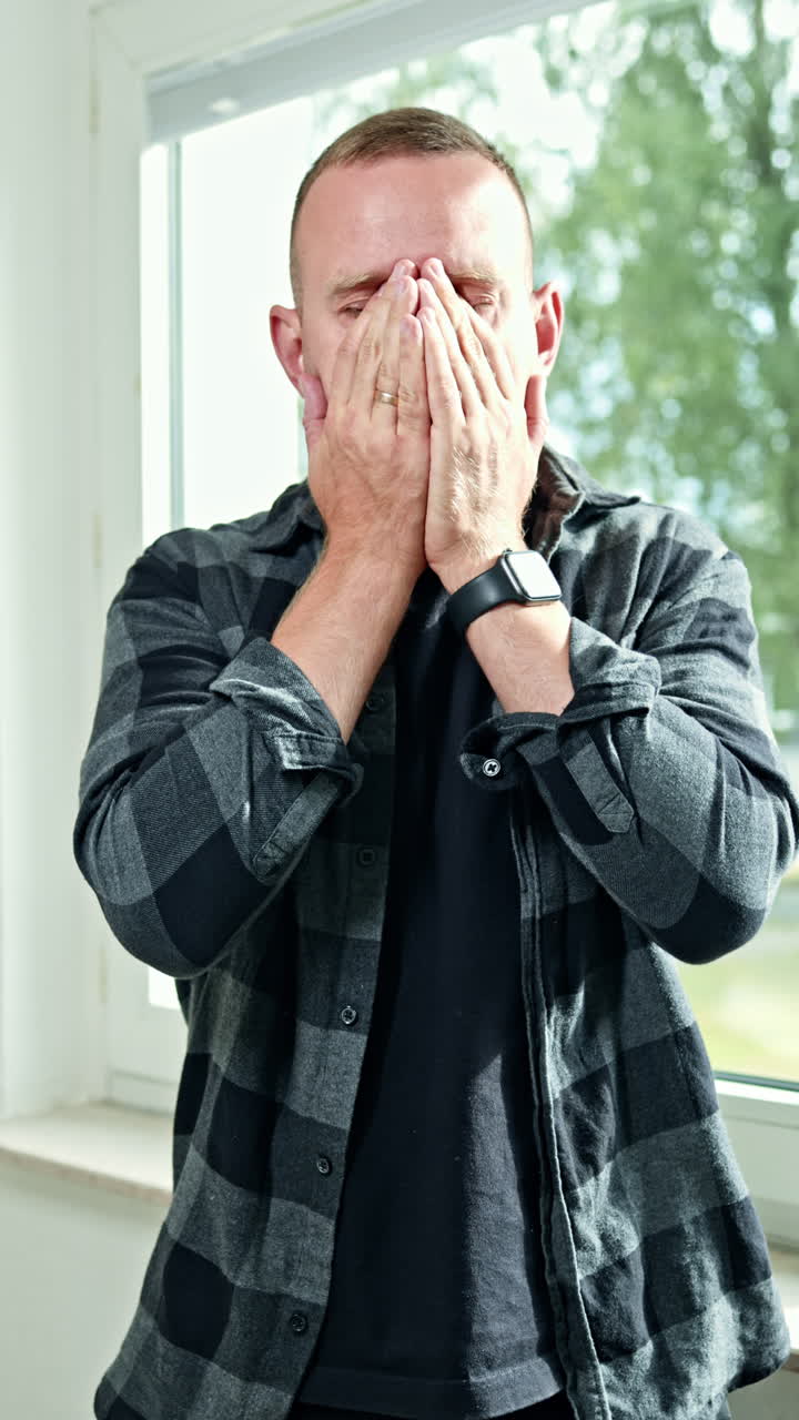 Emotional grimaces on a man's face close-up. A man looks grimly into the camera. A man's face with an angry expression on it. A man looks disdainfully in front of him