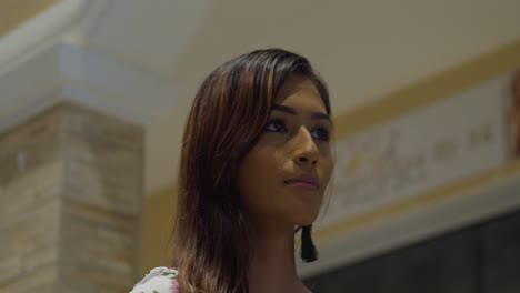 facial closeup of a young woman confidently walking at a mall