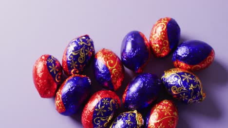 Close-up-of-multiple-chocolate-easter-eggs-on-purple-background