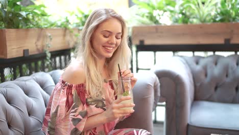 woman enjoying a refreshing drink at a cafe