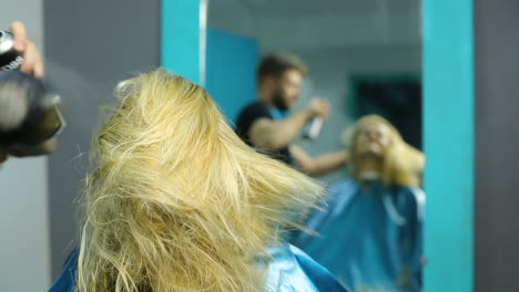 cutting hair at salon. young woman having her hair dyed by beautician at parlor
