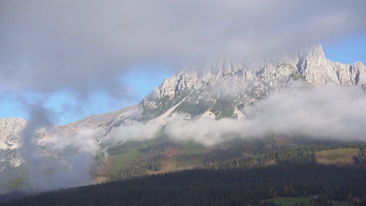 Foggy morning in austrian alps with huge mountain in background, tyrol