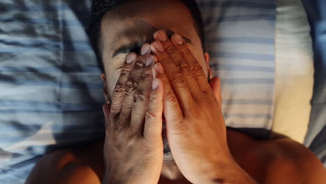 Young-man-waking-up-in-bed