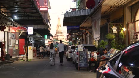 pedestrians and vehicles moving through a market.