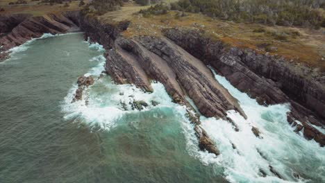 amazing power of the ocean waves breaking against a rocky shoreline