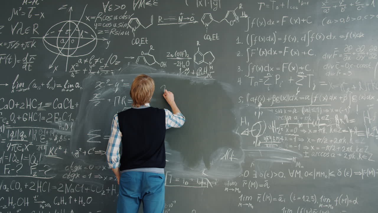 Student Writing Equations on a Chalkboard