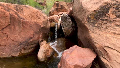 slow motion flowing stream through red rocks in the south desert