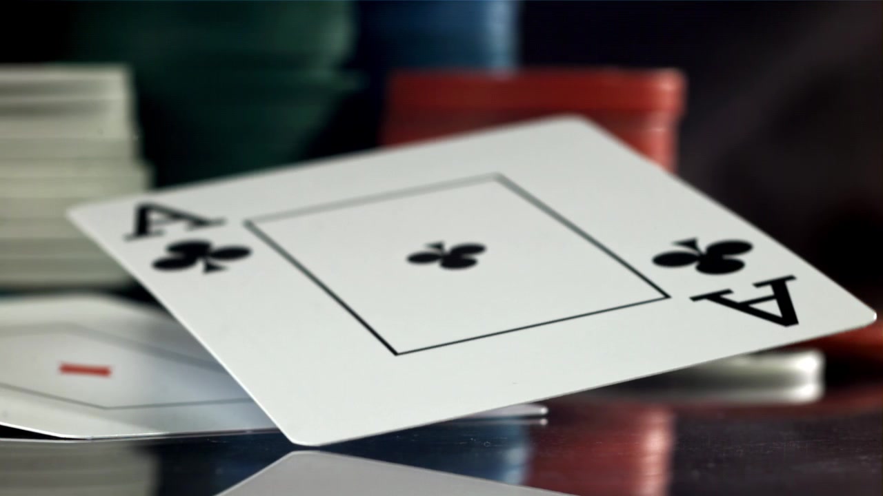 Slow Motion Reveal of Two Aces and Poker Chips