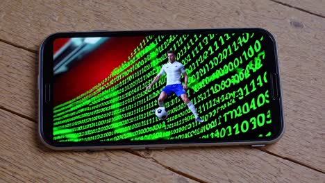 soccer player on a mobile phone screen with binary code background