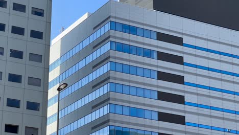 Glass-windows-of-office-buildings-in-Chuo-City,-Tokyo-Japan