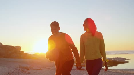 Couple-walking-hand-in-hand-on-the-beach-4k