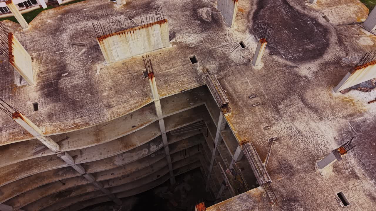 View of a construction site with deep excavation and vertical structures