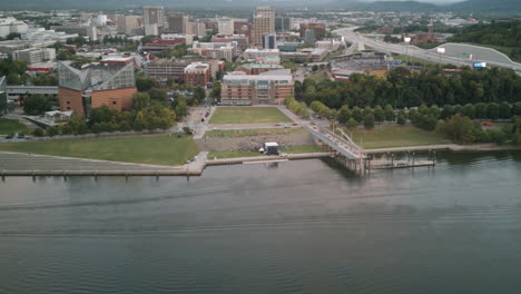 Aerial-hyperlapse-over-the-Tennessee-River-showing-a-party-going-on-on-the-Riverfront-next-to-the-Tennessee-Aquarium-in-downtown-Chattanooga,-TN