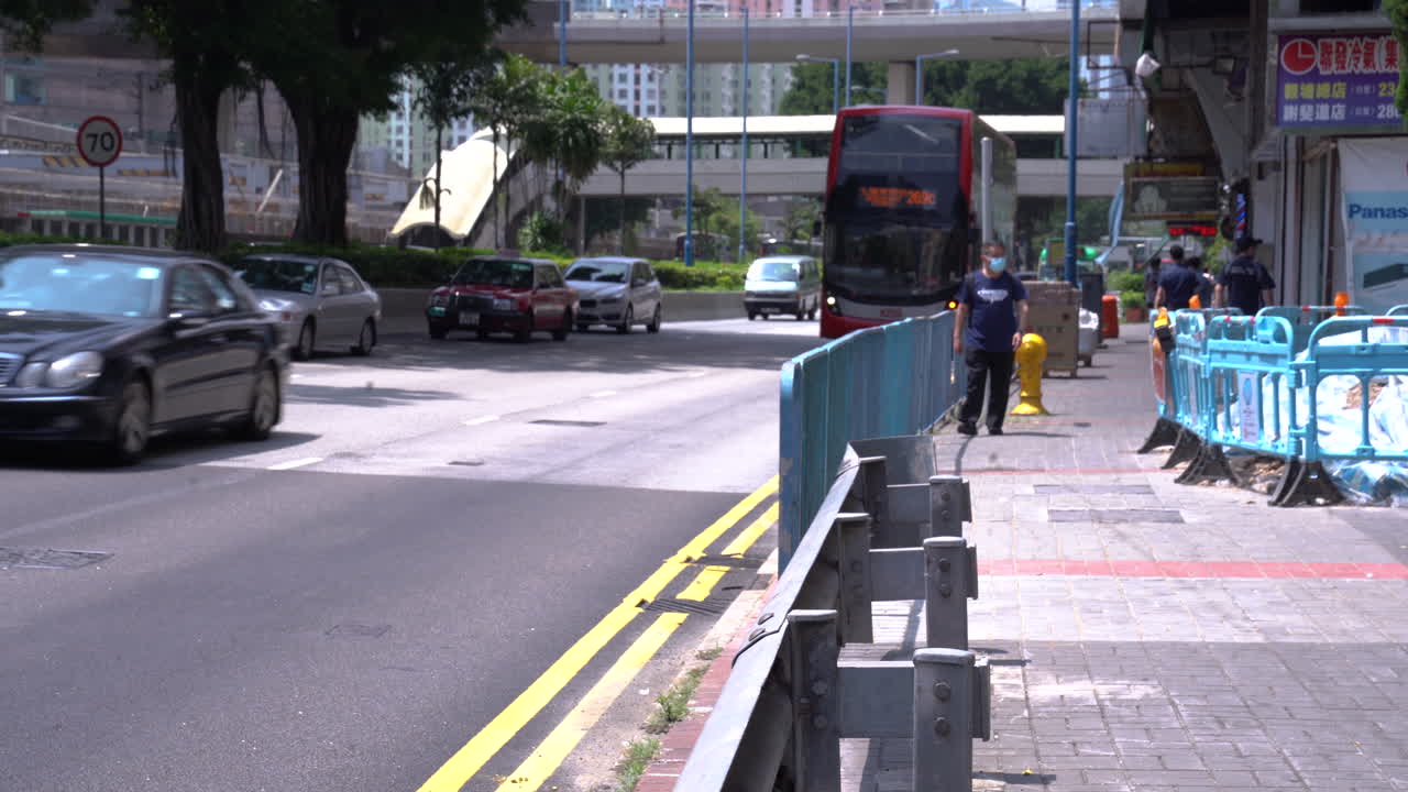 Hong Kong City Street with Double-Decker Buses and Pedestrians