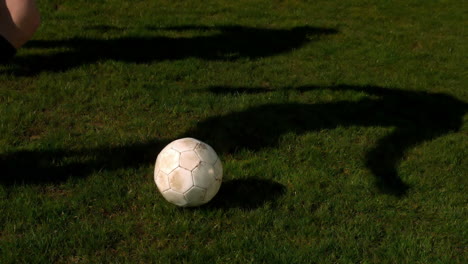 football player controlling the ball on pitch