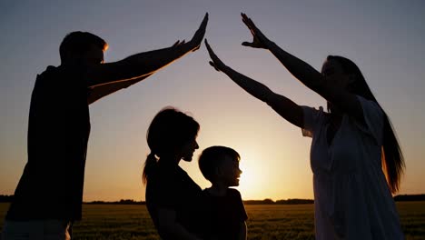 family silhouette at sunset