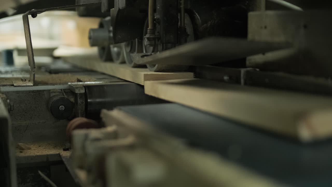 Wood Plank Moving Through an Industrial Woodworking Machine