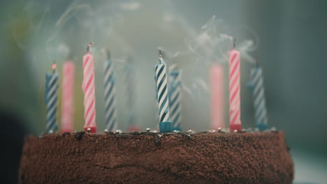 Close-up-view-of-candles-blown-on-chocolate-cake