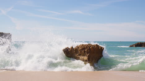 ocean waves crashing at the sea stacks in algarve, portugal - wide