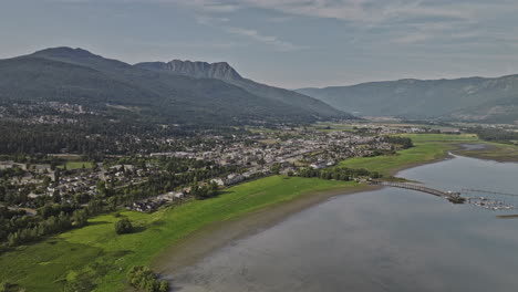 salmon arm bc canada aerial v3 drone flyover shuswap lake capturing town center and picturesque lakefront residential area against backdrop of mountains vista - shot with mavic 3 pro cine - july 2023