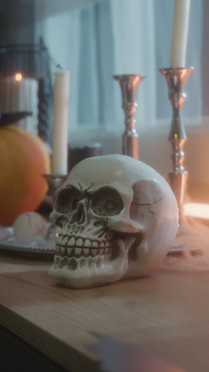 Halloween Still Life with Skull, Candles, and Pumpkin