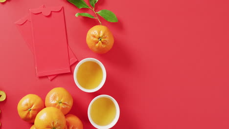 video of envelopes, oranges and bowls on red background