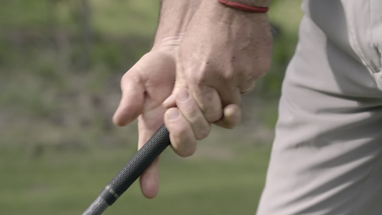 Detail of golf player gripping driver handle