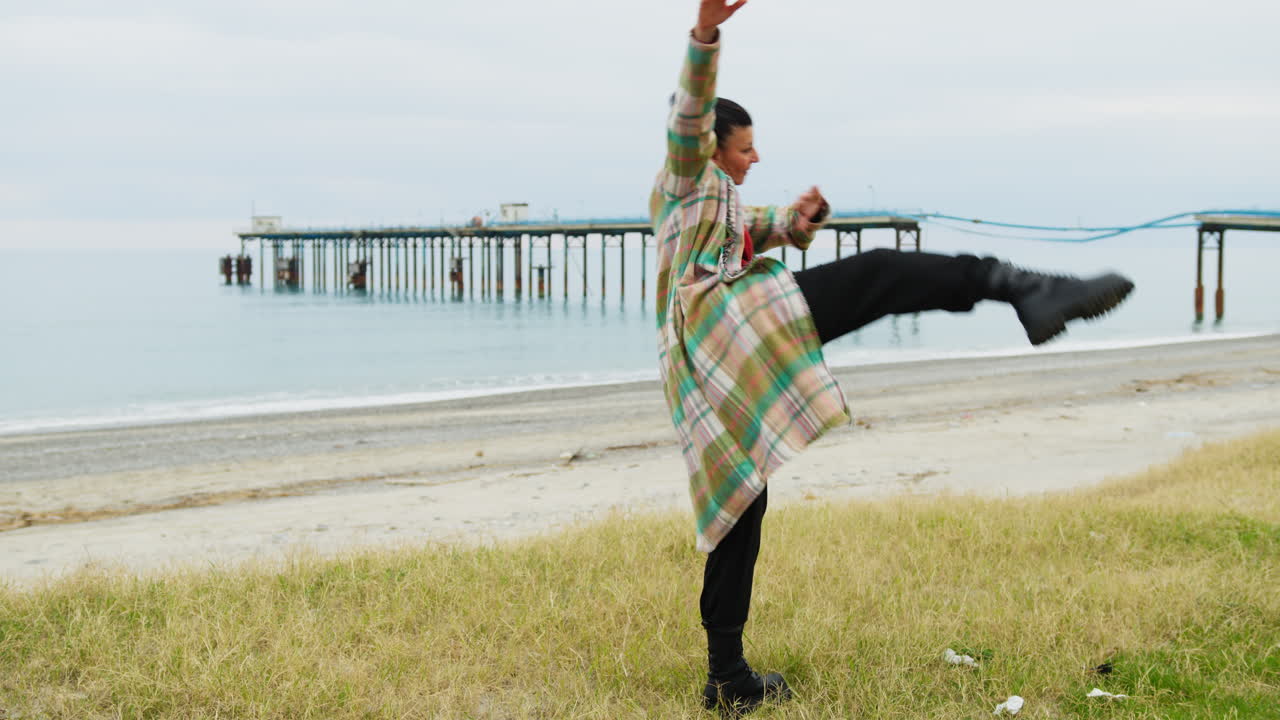 Near A Polluting Pier In The Ocean A Woman Dances In Defense Of Nature