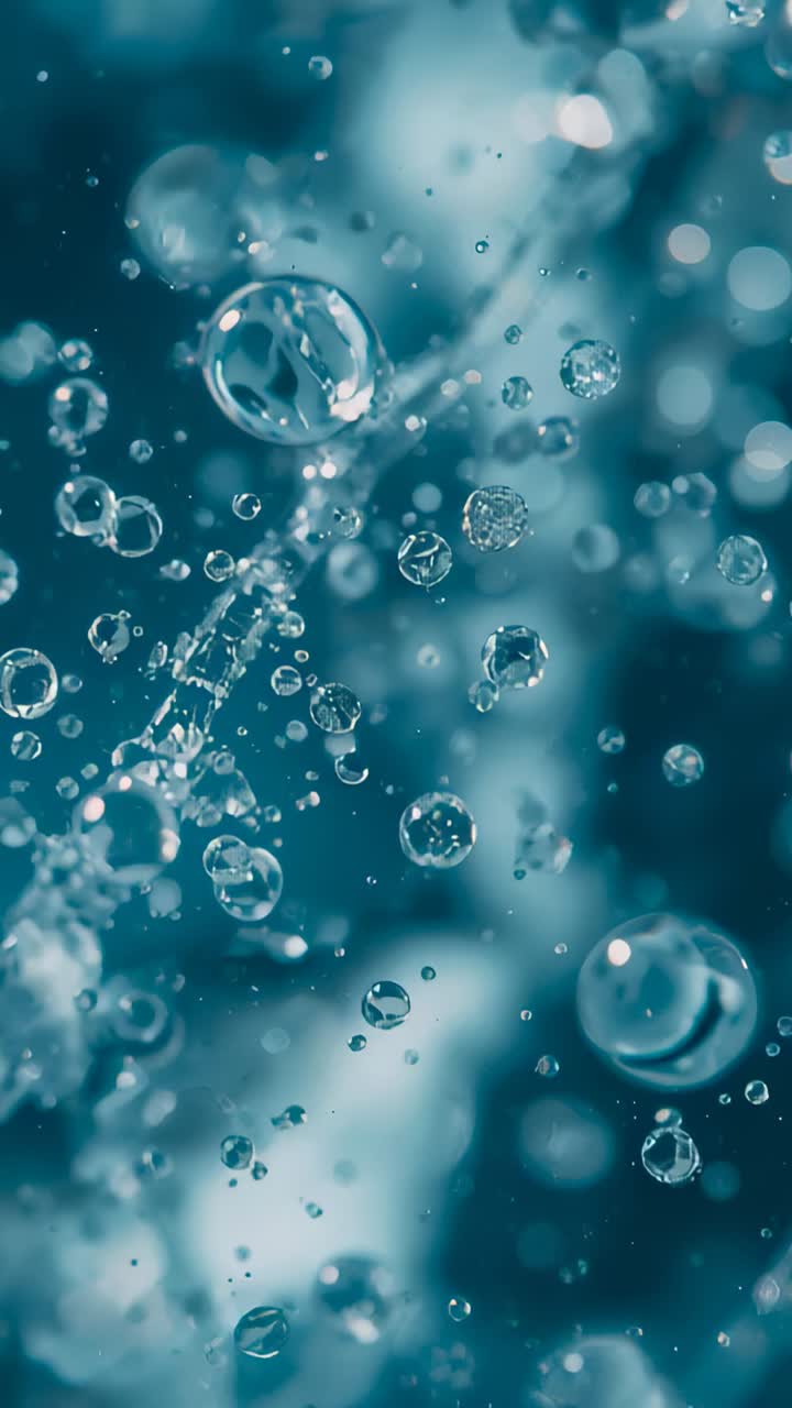 Video verticale: bolle che si spostano verso l'alto in un liquido macro all'inizio della sequenza, formando un filamento