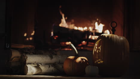 near the fireplace are firewood and a glowing pumpkin. halloween home decoration