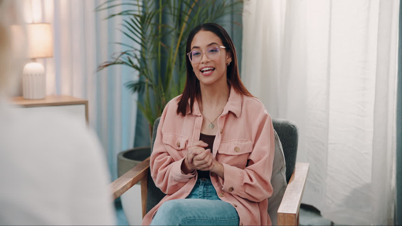 A Woman Sitting In A Chair Talking To Someone