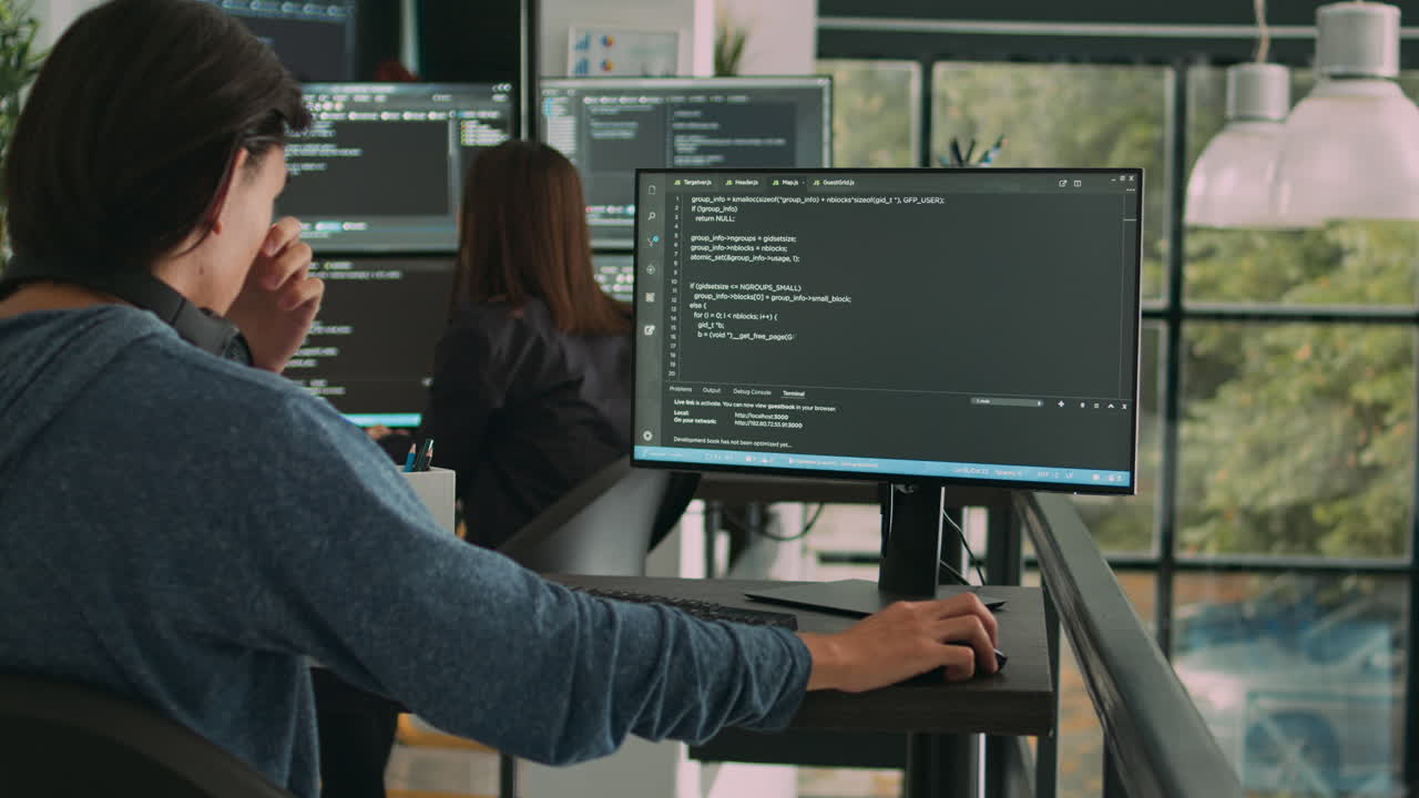 Software programer typing source code on computer keyboard