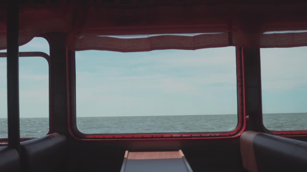 Shot made inside the ferry capturing calm sea over the window