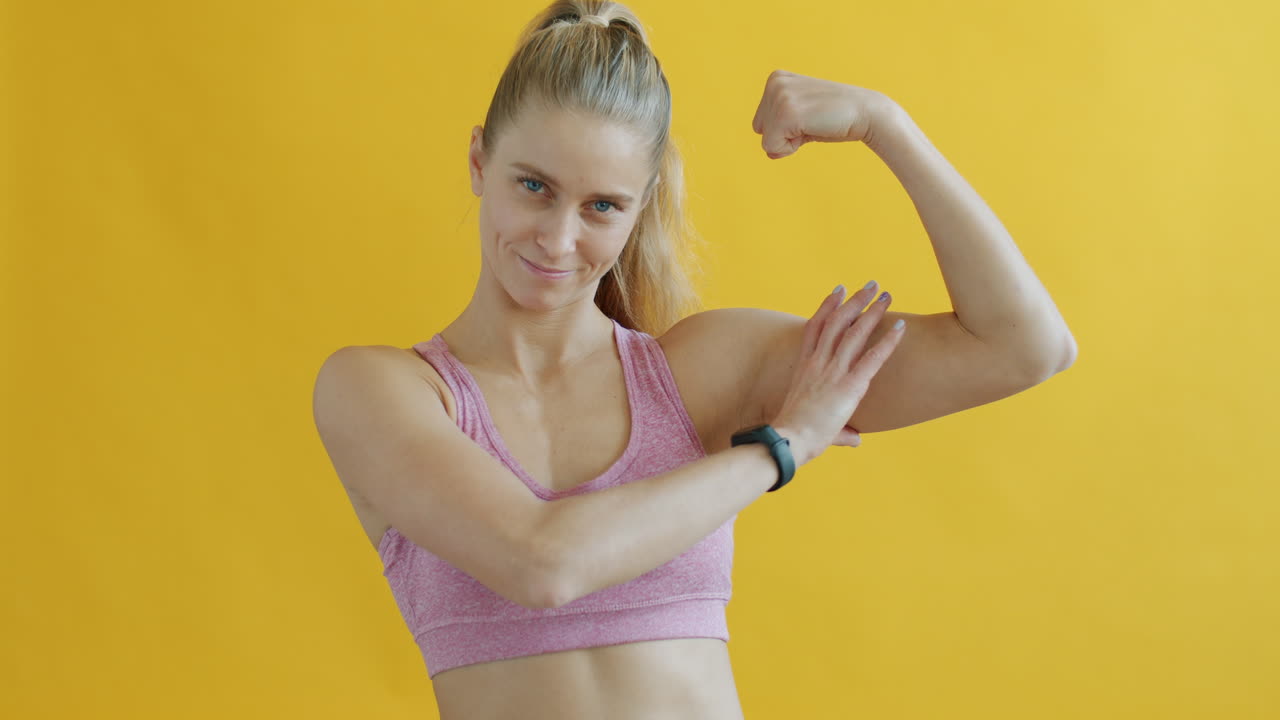 Woman flexing in sports bra