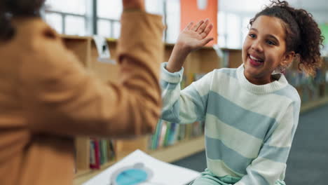 a girl gives a high five in a library