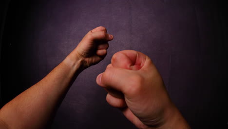 man's fists in front of him before the fight gesture captured from left side looking gracefully in front of camera fisheye perspective with daylight all capture in 4k 60fps slow motion movement