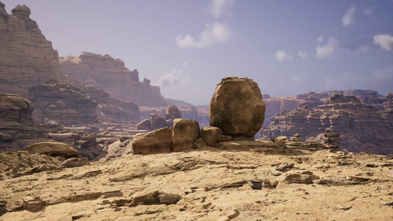 Vast rocky landscape with large boulders under a clear sky in daylight