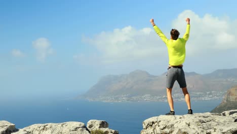 male hiker walking on a edge of rocky mountain 4k