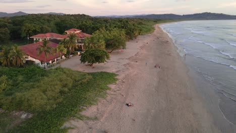 fast fly-over at playa grande near tamarindo, costa rica during warm and vibrant sunset