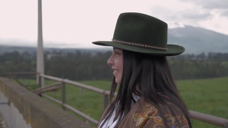 beautiful cowgirl laughing next to the farm