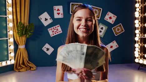 woman celebrating with money and cards