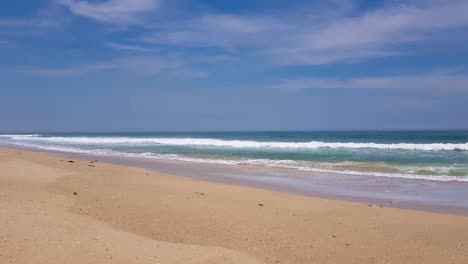 peace waves crash onto the beach in this wide shot of the ocean in south africa