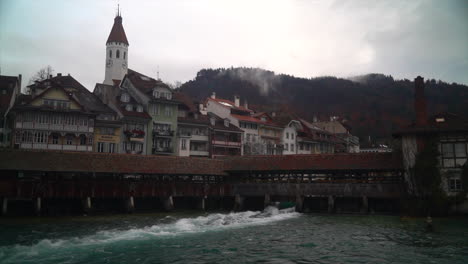 Cinematic-Thun-river-surf-wave-cloudy-downtown-historic-Switzerland-Swiss-town-castle-Schlossberg-Interlaken-Thunersee-peaceful-lock-winter-birds-flying-tripod-still