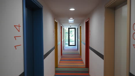 colorful hotel hallway with striped carpet